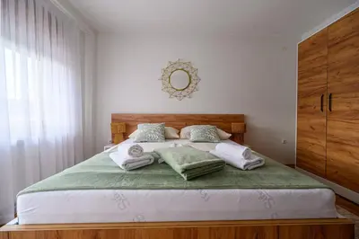 a bedroom with a bed with towels on it at Apartman HAAN in Bihać