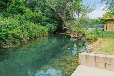 a river with a stick in the water at Hafizove ville na Uni in Illidža