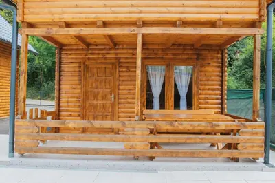 a log cabin with a door and a window at Hafizove ville na Uni in Illidža