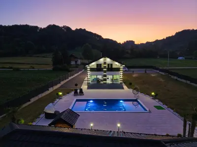 a house with a swimming pool in front of a house at Villa La Casa Del Sol in Srebrenik