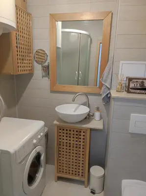 a bathroom with a sink and a washing machine at Apartman Doma in Livno