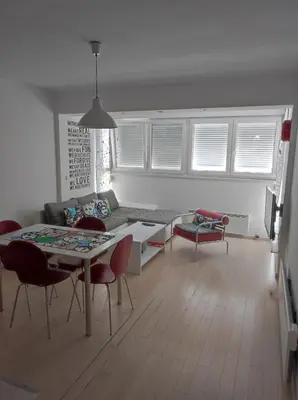 a living room with a couch and a table and chairs at Apartman Doma in Livno