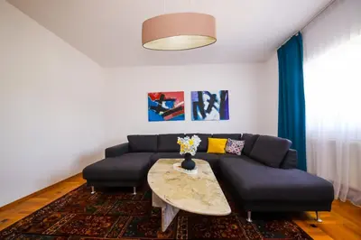a living room with a couch and a table at Khalilah Apartment 3 in Bihać