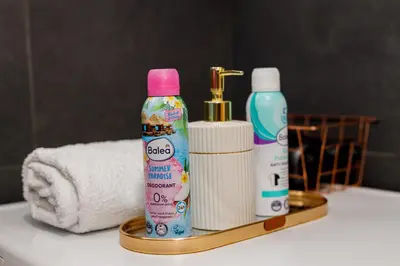 a bathroom with two bottles of soap and a towel at Khalilah Apartment 3 in Bihać