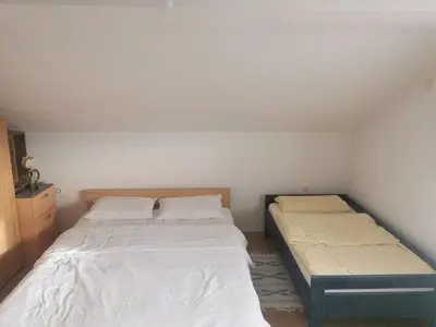 a small bedroom with two beds in it at House Crkvina