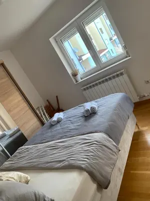 a bedroom with a bed with two towels on it at Apartment Boky in Livno