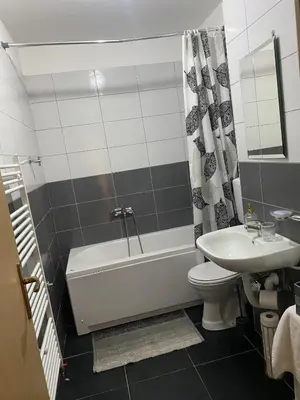 a bathroom with a tub and a toilet and a sink at Apartment Boky in Livno