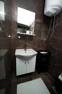 a bathroom with a sink and a mirror at Apartmani M&DŽ Bihać in Bihać