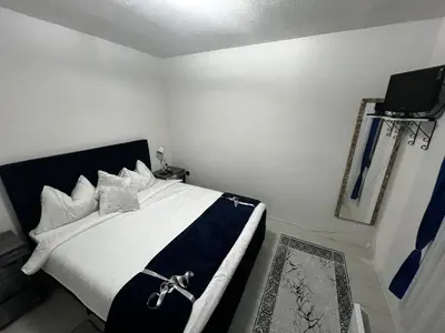 a bedroom with a bed with a cross on it at Apartmani M&DŽ Bihać in Bihać