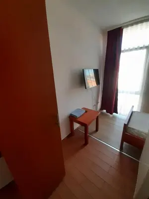 a living room with a table and a window at Motel Plaza in Bihać