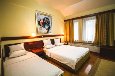 a hotel room with two beds and a window at Hotel Vila Vrbas in Banja Luka