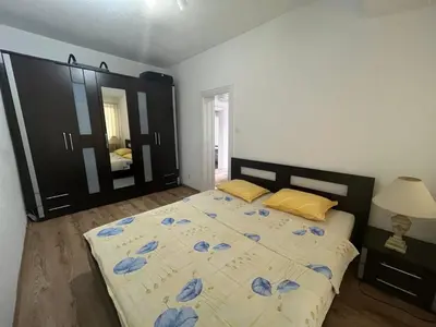 a bedroom with a bed with blue flowers on it at Apartman Serdjo