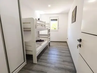 a small room with a bunk bed and a door at The Crown Panorama in Jajce
