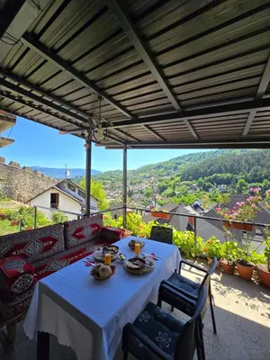 a table and chairs on a balcony with a view at The Crown Panorama in Jajce