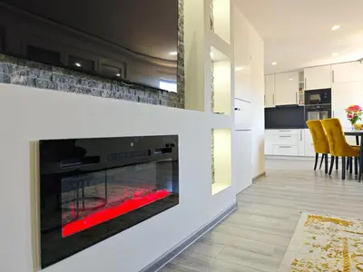 a fireplace in a living room with a red fire place at The Crown Panorama in Jajce