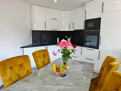 a kitchen with a table with a vase of flowers at The Crown Panorama in Jajce