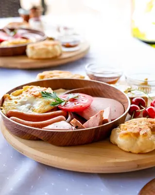 a table with a wooden bowl of food on a table at The Crown Panorama in Jajce