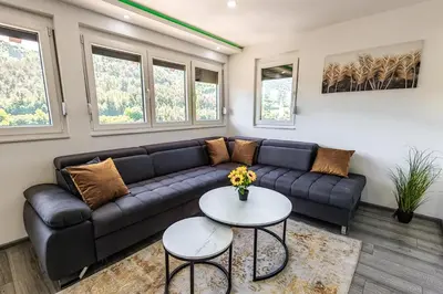 a living room with a couch and a table at The Crown Panorama in Jajce