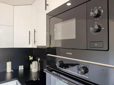 a black and white kitchen with a microwave at The Crown Panorama in Jajce