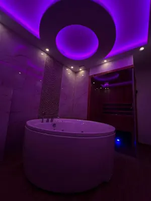 a bathroom with a purple lighting and a tub at Elita SPA in Doboj