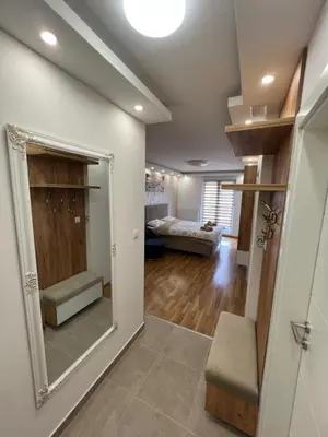 a living room with a mirror and a couch at Elita SPA in Doboj