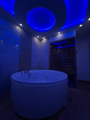 a bathroom with a large tub with a blue ceiling at Elita SPA in Doboj