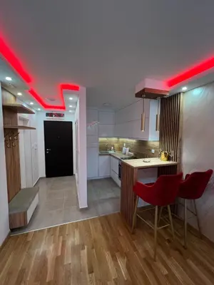 a large kitchen with red lighting in a room at Elita SPA in Doboj
