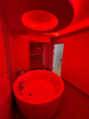a red bathroom with a large tub in a red room at Elita SPA in Doboj