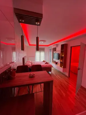 a living room with red lights on the ceiling at Elita SPA in Doboj