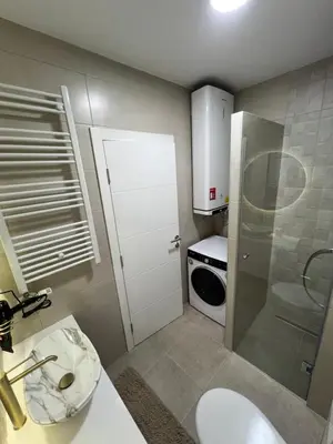a small bathroom with a sink and a microwave at Elita SPA in Doboj