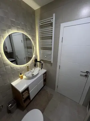 a bathroom with a white sink and a mirror at Elita SPA in Doboj