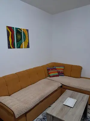 a living room with a couch and a table at Insula in Otoka