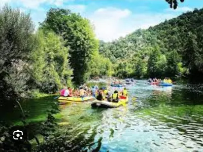 a group of people in boats on a river at Insula in Otoka