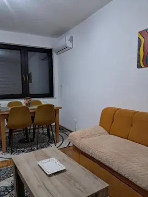 a living room with a couch and a table at Insula in Otoka