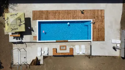 an overhead view of a swimming pool with chairs and a table at JAGI Bungalovi Mrkonjic Grad in Mrkonjić Grad