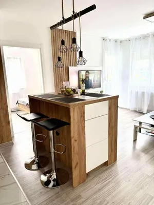 a kitchen with a wooden counter with a bar at Bella LUX in Modriča