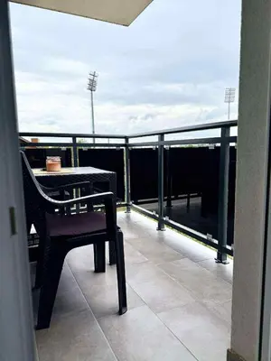 a balcony with a table and a chair on a roof at Bella LUX in Modriča