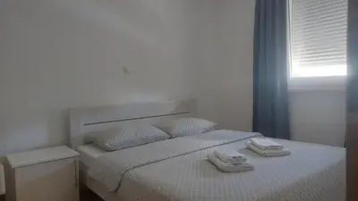 a bedroom with a bed with two towels on it at Apartman Mario in Tomislavgrad