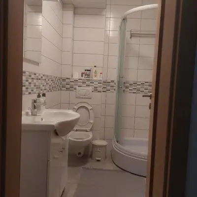 a bathroom with a sink and a toilet and a shower at Apartman Mario in Tomislavgrad