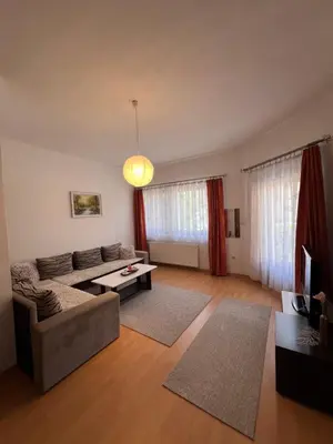 a living room with a couch and a table at Apartmani Odmor Fojnica in Fojnica