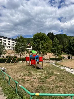a park with a playground in a field at Apartmani Odmor Fojnica in Fojnica