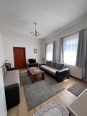 a living room with a couch and a table at Apartmani Odmor Fojnica in Fojnica