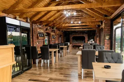 a row of tables and chairs in a wine cellar at Etno Camp Lucić in Odžak
