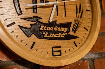 a clock with a picture of a bird on it at Etno Camp Lucić in Odžak