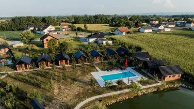 an aerial view of a home with a swimming pool and a resort at Etno Camp Lucić in Odžak