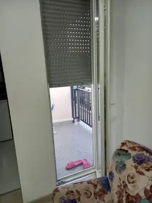 a mirror in a room with a door with a doorway with a view at Stan Živinice bb in Živinice