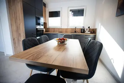 a wooden table in a kitchen with a bowl of fruit on it at Villa Ena in Praščijak