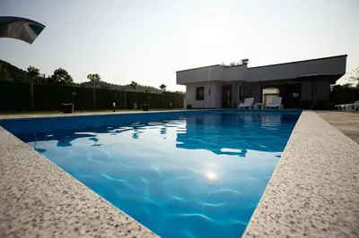 a swimming pool in front of a house at Villa Ena in Praščijak