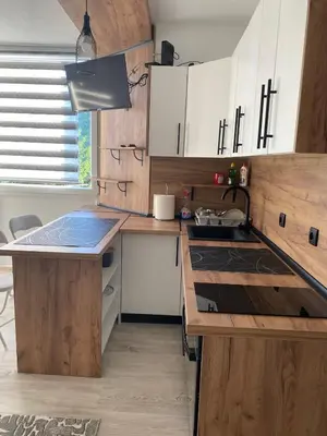 a kitchen with wooden cabinets and a counter top at Stay for 2 in Jajce