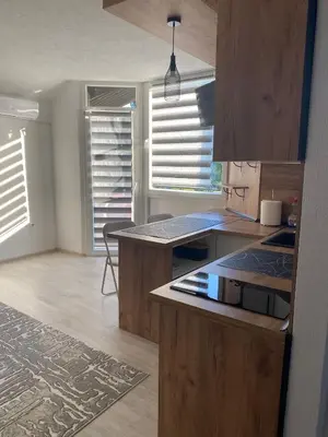 a kitchen with wooden cabinets and a counter top at Stay for 2 in Jajce